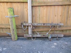 Two wooden crossarms and a collection of telegraph pole crossarms parts awaiting restoration