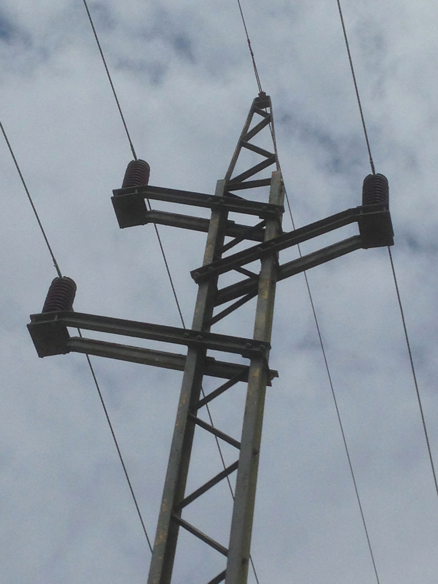 Oh look, it's a bloody pylon. Close up of the top of a small pylon in Sussex