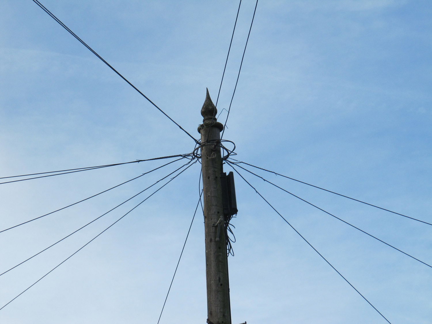 Telephone pole with an ordinary finial on top