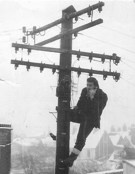 Ronald Coleman up an olde worlde telegraph pole in Kent
