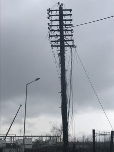 A telegraph pole with 8 cross arms about to be removed from Ashford railway yard in Kent.