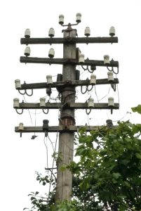 Closeup of the arms and insulators on a 1932 5 armed telegraph pole near Ruthin, North Wales.