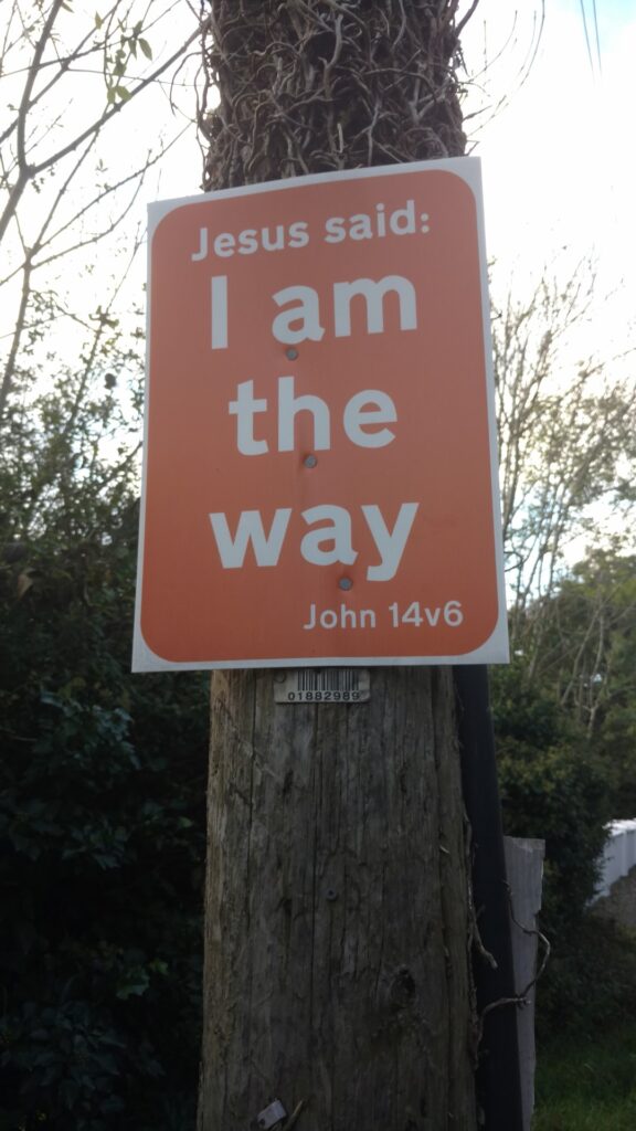 A poster on a four armed pole near Dundalk which reads "Jesus says I am the way"